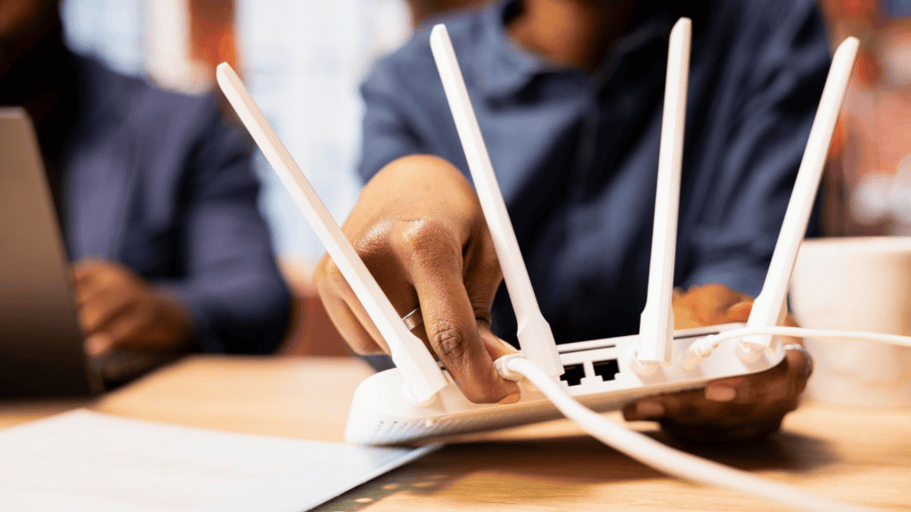 mulher conectando cabo de internet em um roteador branco em cima de uma mesa